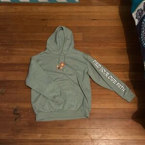 A green hoodie with floral print